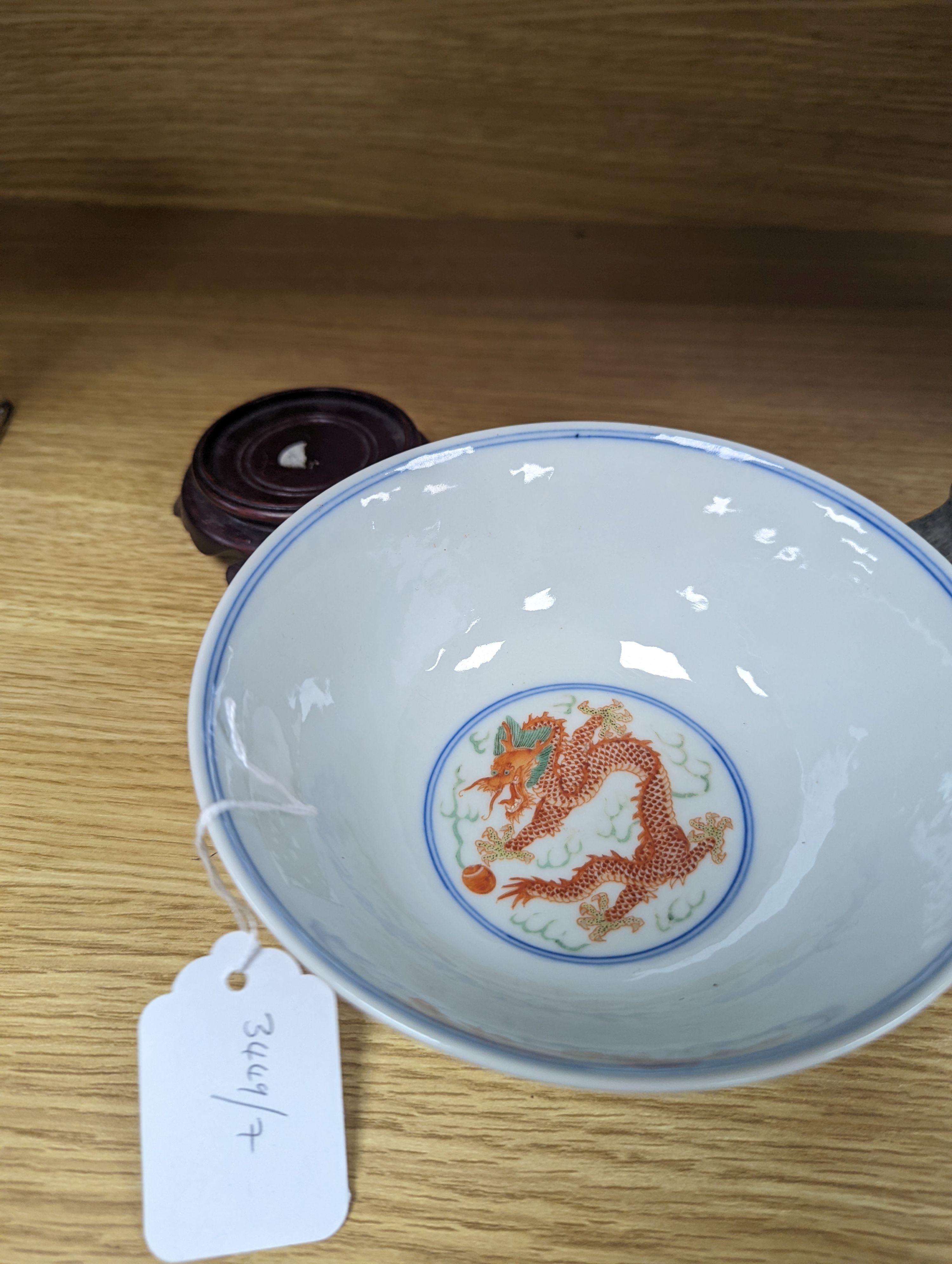 A Wucai bowl, dragon and flamingo pearl decoration, Jiaqing mark, on wood stand. 16cm diameter